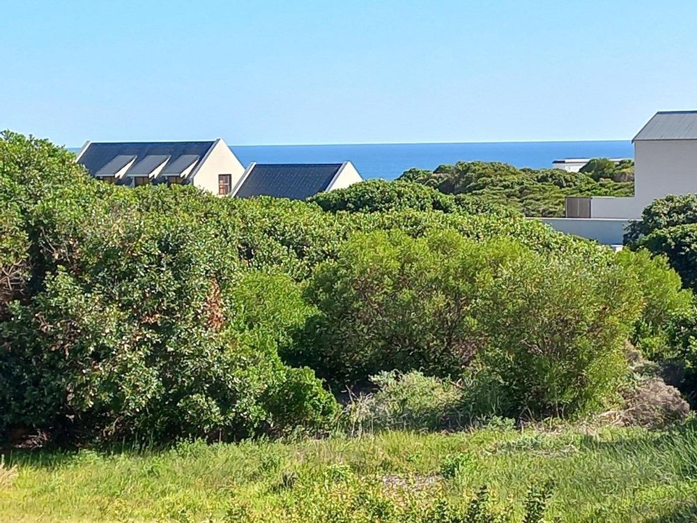 View slightly to our right; Stanfords Cove "beach" in front of dark-roofed Dwelling.