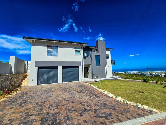 For Sale: House in Stilbaai Oos with sea views, open-plan living, and security.