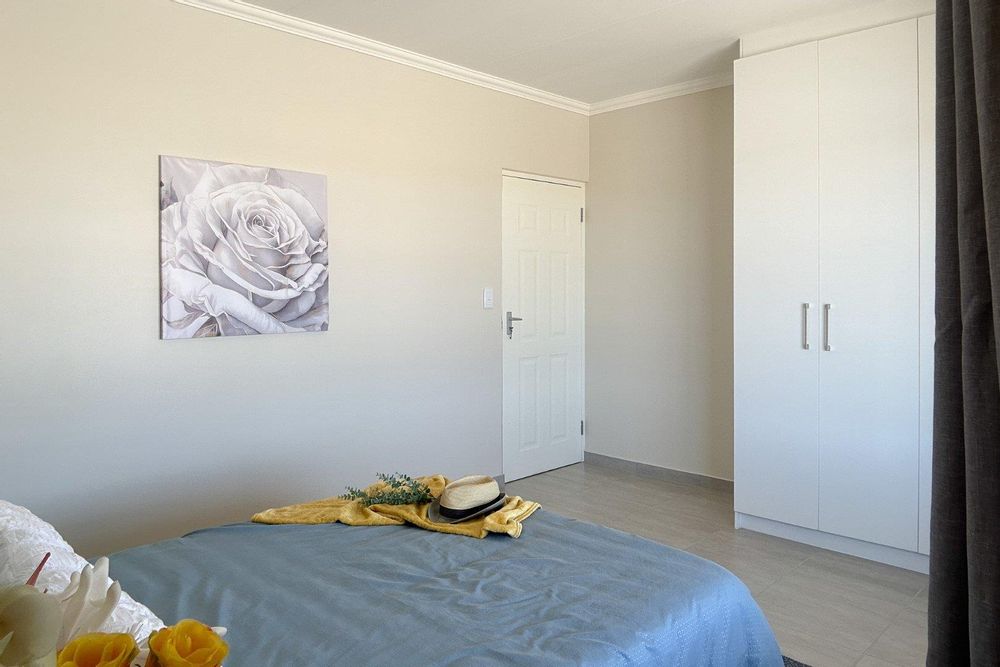 Spacious main bedroom with built-in cupboards.