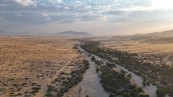 Farm for Sale in Usakos Central: 10,000 ha with river frontage, plots, and amenities.