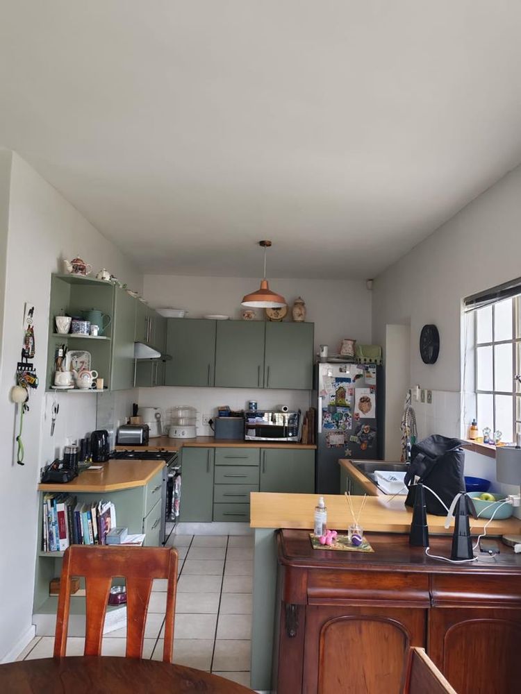 comfortable kitchen with lots of storage leading to a tugged away washing / laundry area  with back door and entrance to garage direct from the house 