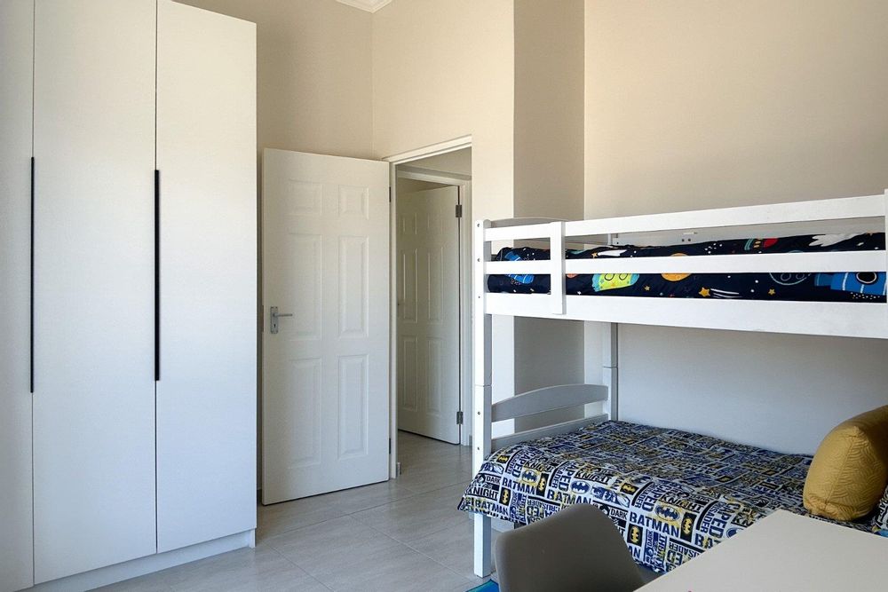 Second bedroom with built-in cupboards.