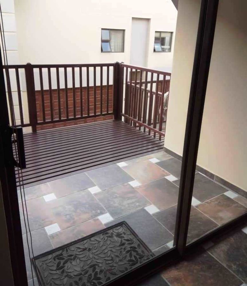 Sliding doors opening onto balcony with outdoor BBQ