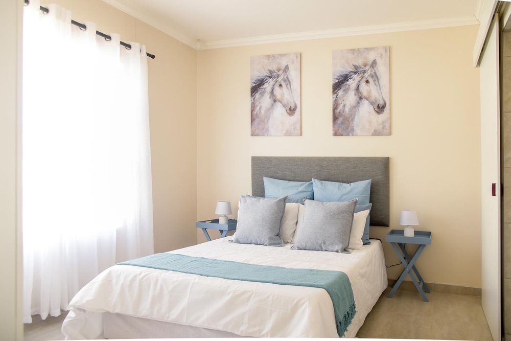 Main bedroom with built-in cupboards and ensuite bathroom.