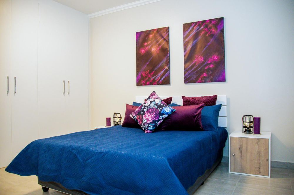 Main bedroom with built-in cupboards and ensuite bathroom.