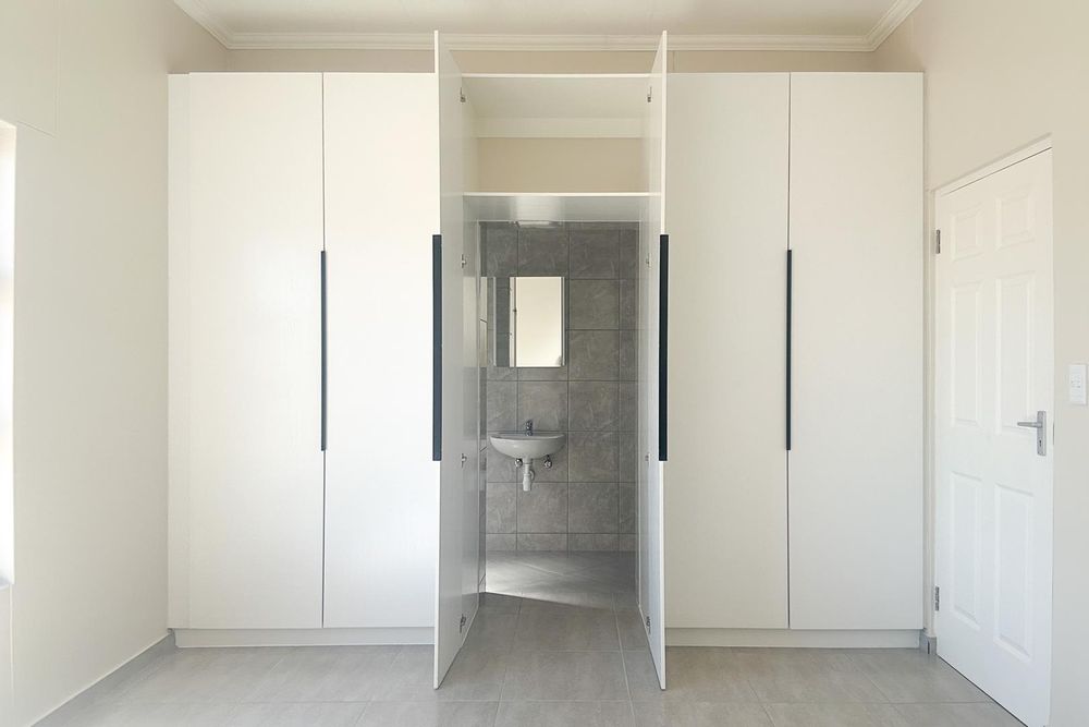 Main bedroom - cupboards with walk-in ensuite bathroom.