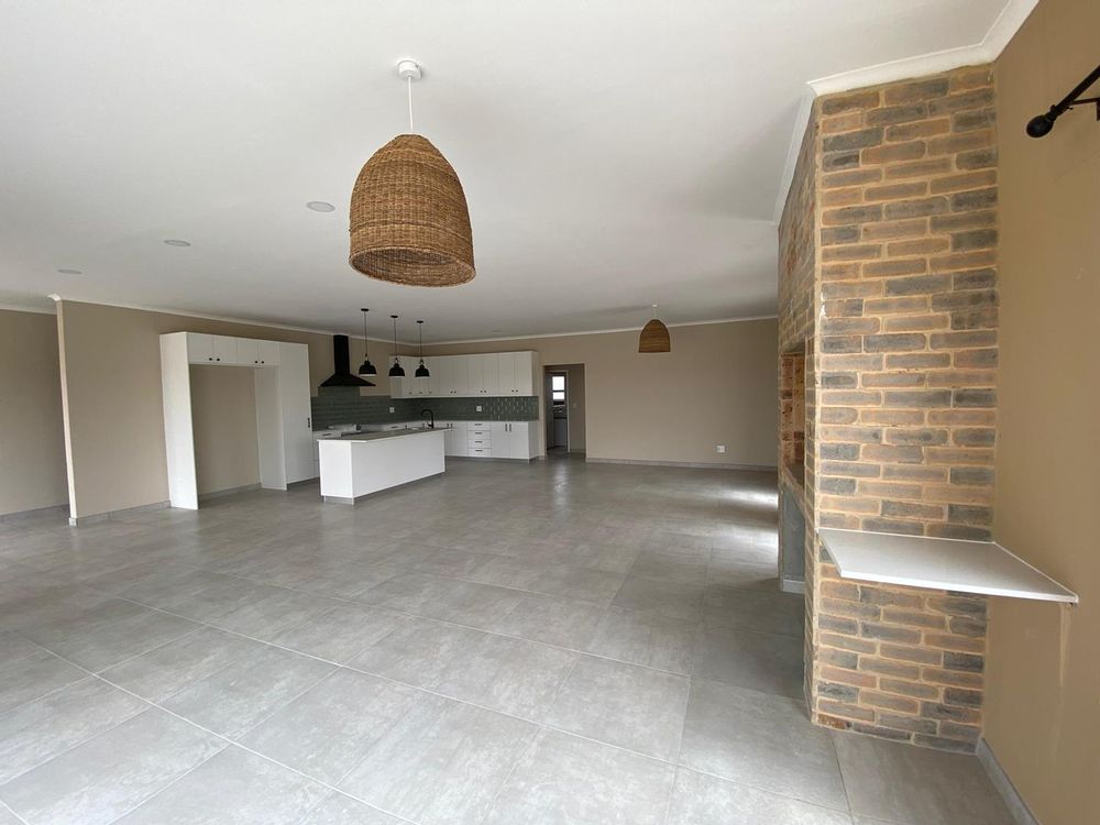 Open plan kitchen, lounge and dining room with an indoor BBQ