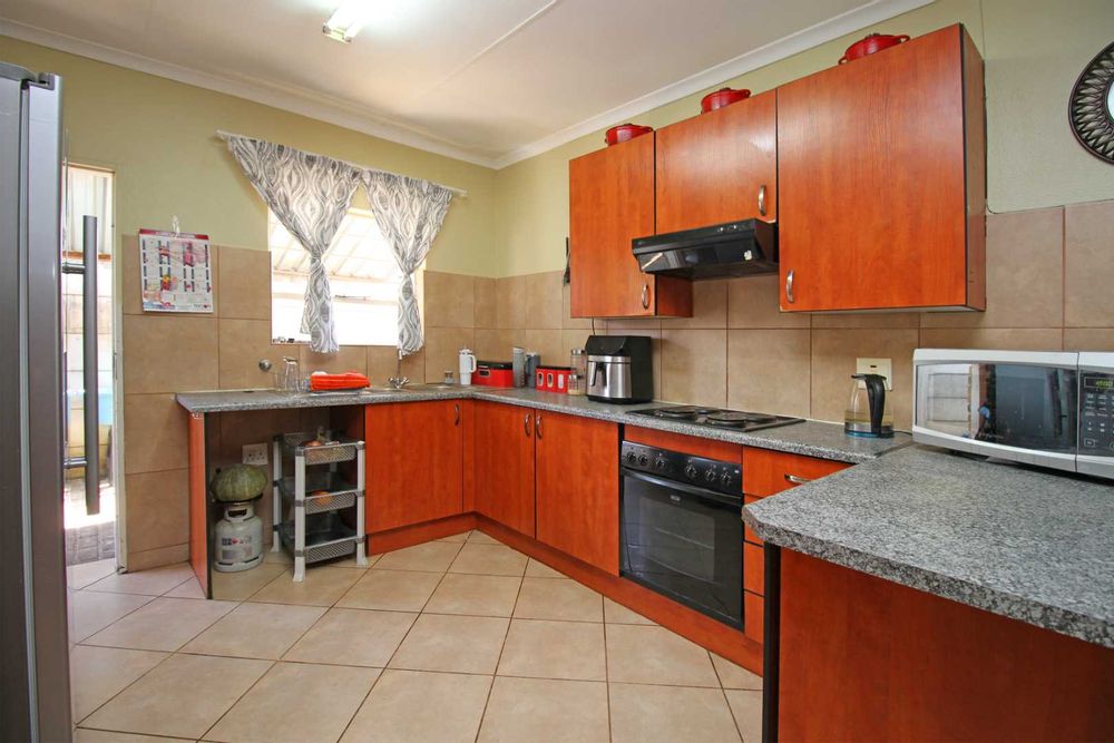 Open Plan Kitchen with modern amenities and kitchen cabinets ideal for family life