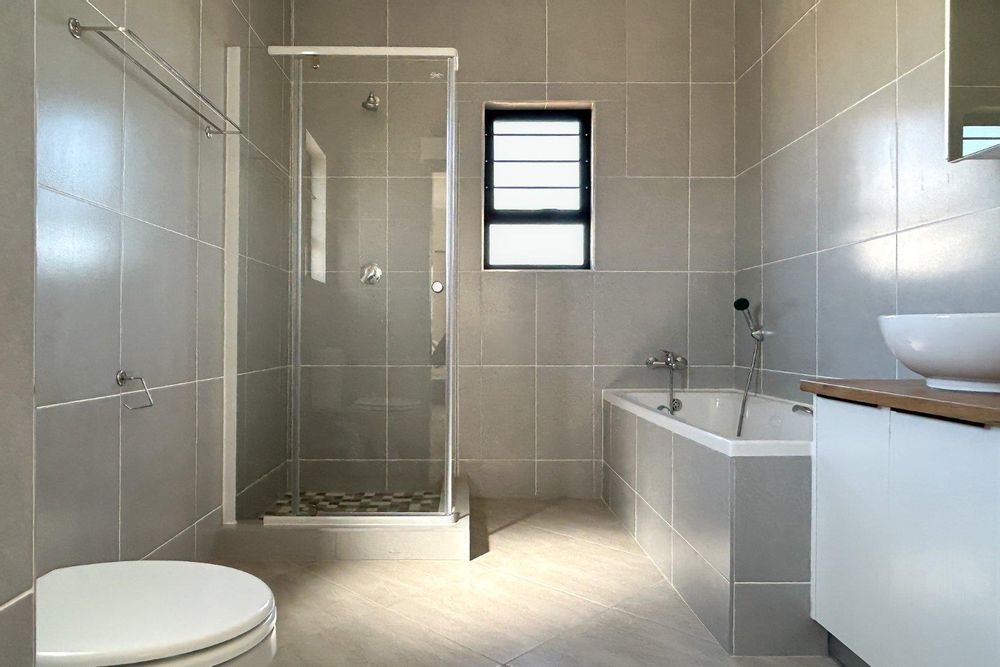 Family bathroom with both shower and bath.