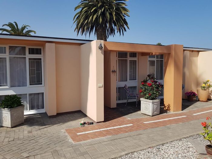 For Sale: Ground-level unit in Vineta Retirement Village with gardens, garages, and en-suites.