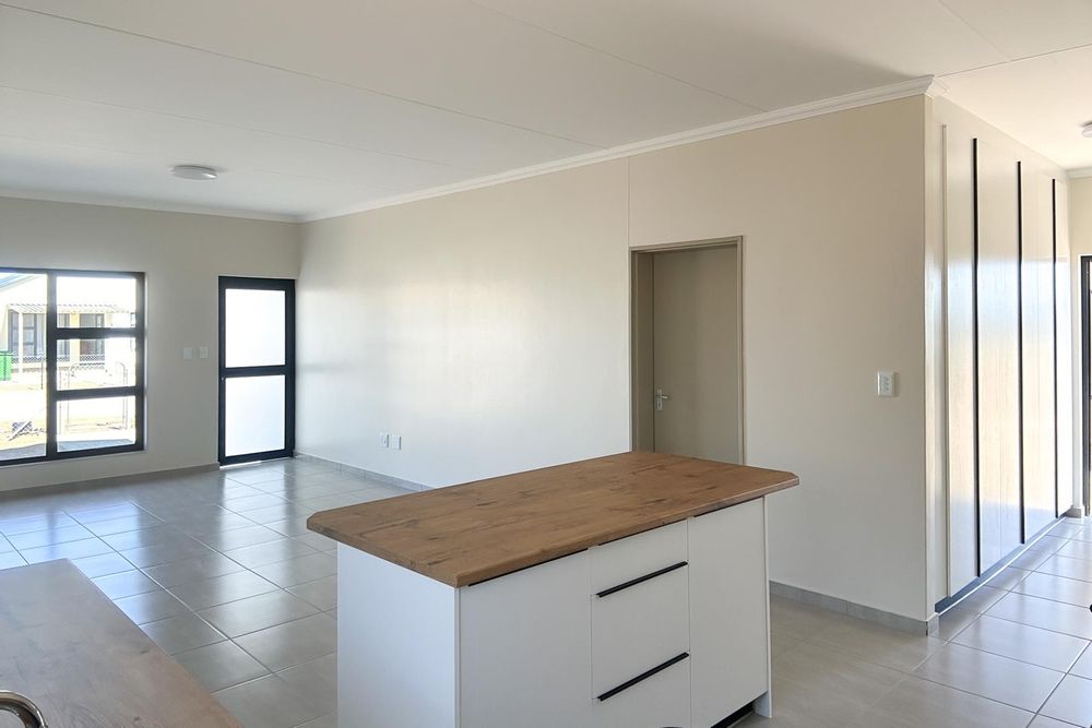 Modern open plan living area with integrated kitchen.