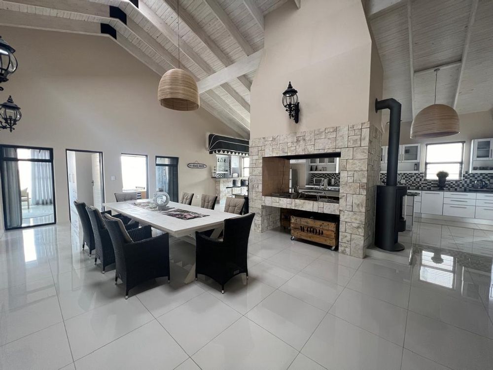 Open-plan kitchen, lounge and dining area with indoor BBQ 