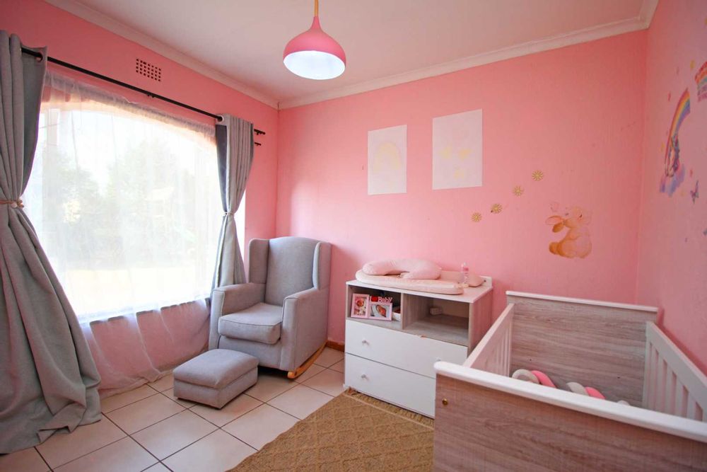 Bedroom 3 : The Nursery with Baby Cot, Baby Compactum Unit and Wing Back Armchair and matching Ottoman, with Built-In Cupboards and Tiled Floors