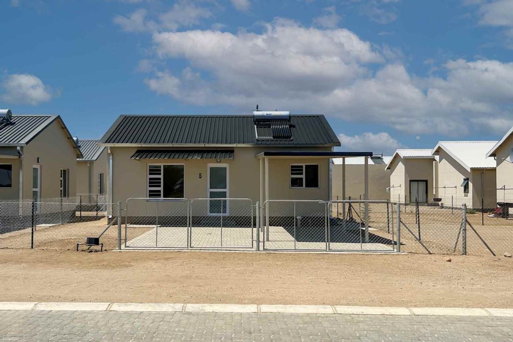 Freestanding townhouse with provision for future expansion and carport.