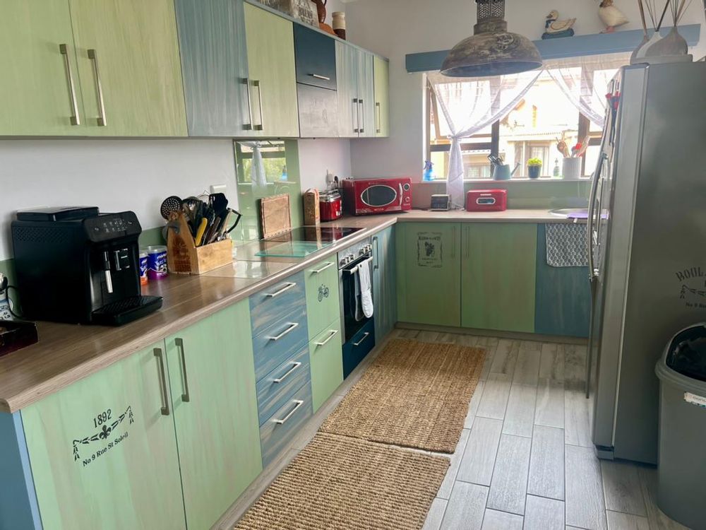 Kitchen with colorful built in cupboards