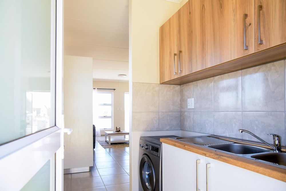 Kitchen scullery with even more cupboards.