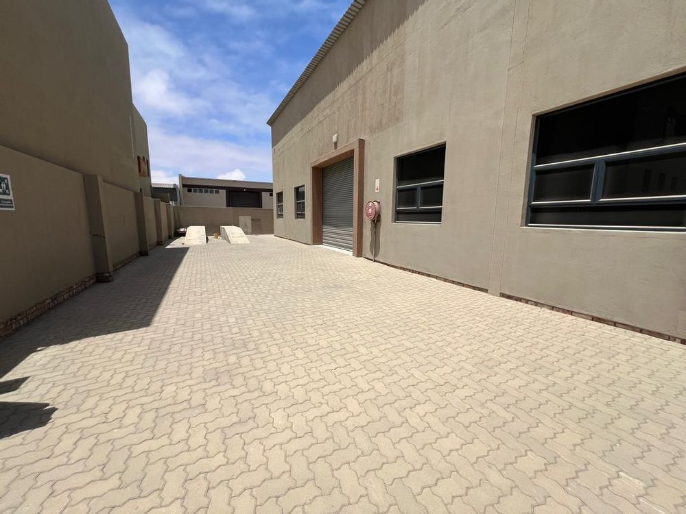 Side entrance 2 with ramp and rolling gate leading to showroom/warehouse