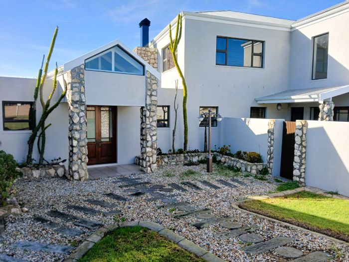 For Sale: Spacious house in Still Bay West with panoramic views and four garages.