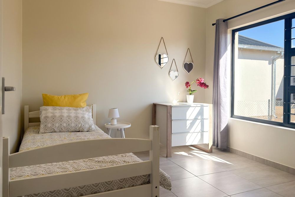 Second bedroom with built-in cupboards.