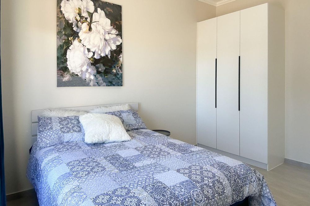 Second bedroom with built-in cupboards.