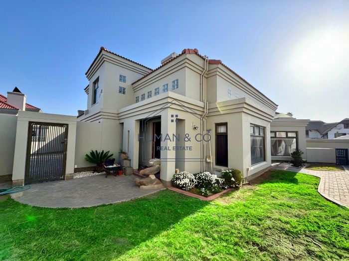 For Sale: House in Meersig with pool, garage, BBQ patio, and lagoon views.