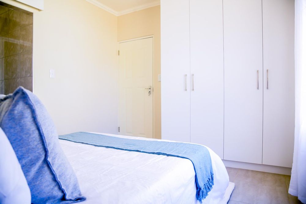 Main bedroom with built-in cupboards and ensuite bathroom.