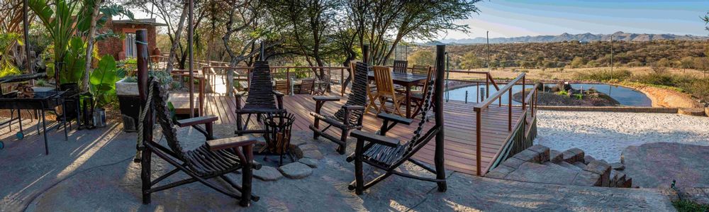 Deck with fire place and a dam in the back ground