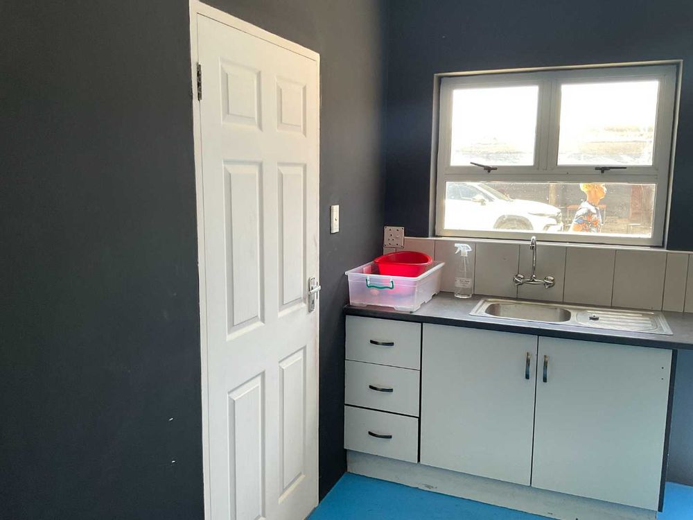 VIEW OF KITCHENETTE AND DOOR TO HALF BATHROOM