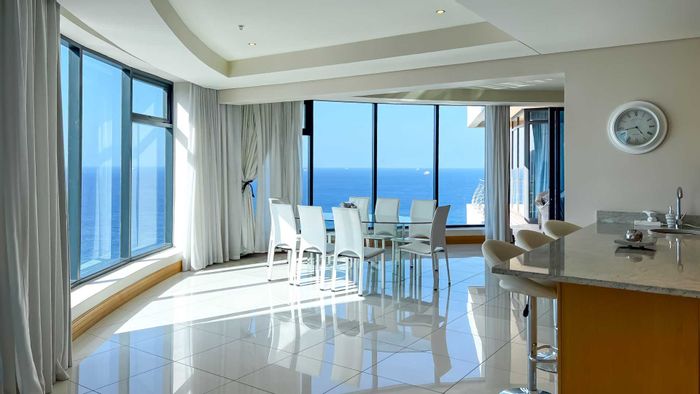 Spacious 6-bedroom apartment with sea views, pool, and direct mall access in Umhlanga Rocks Central. For Sale.