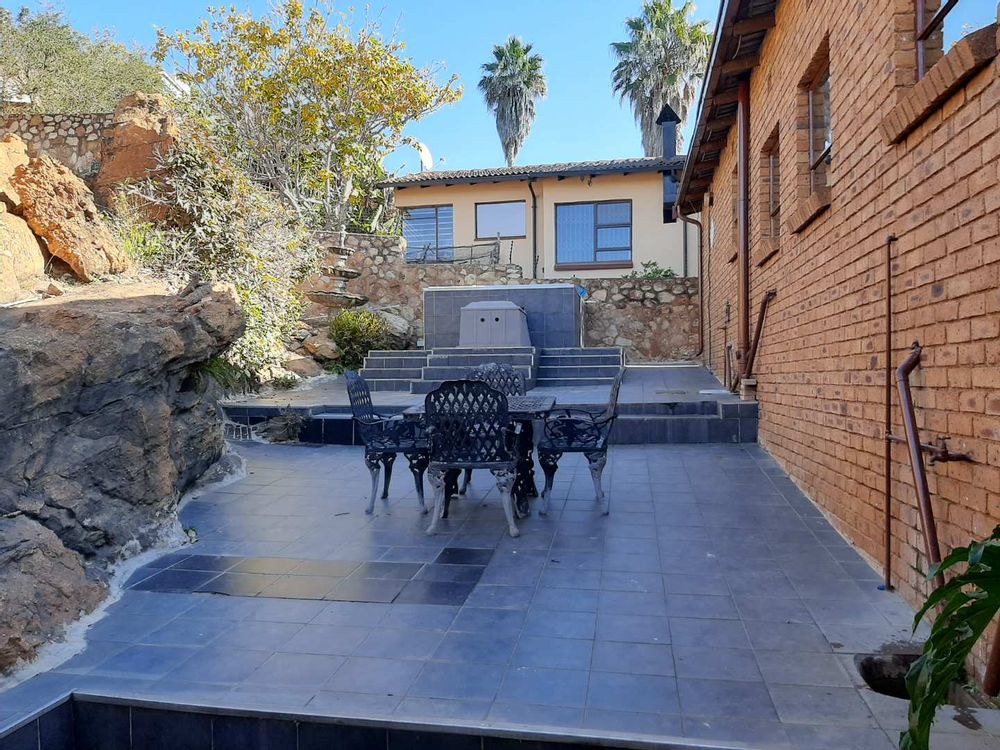 Paved back yard with pool