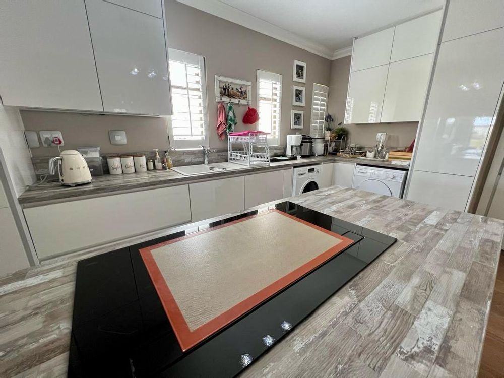 Kitchen with built-in cupboards and stove