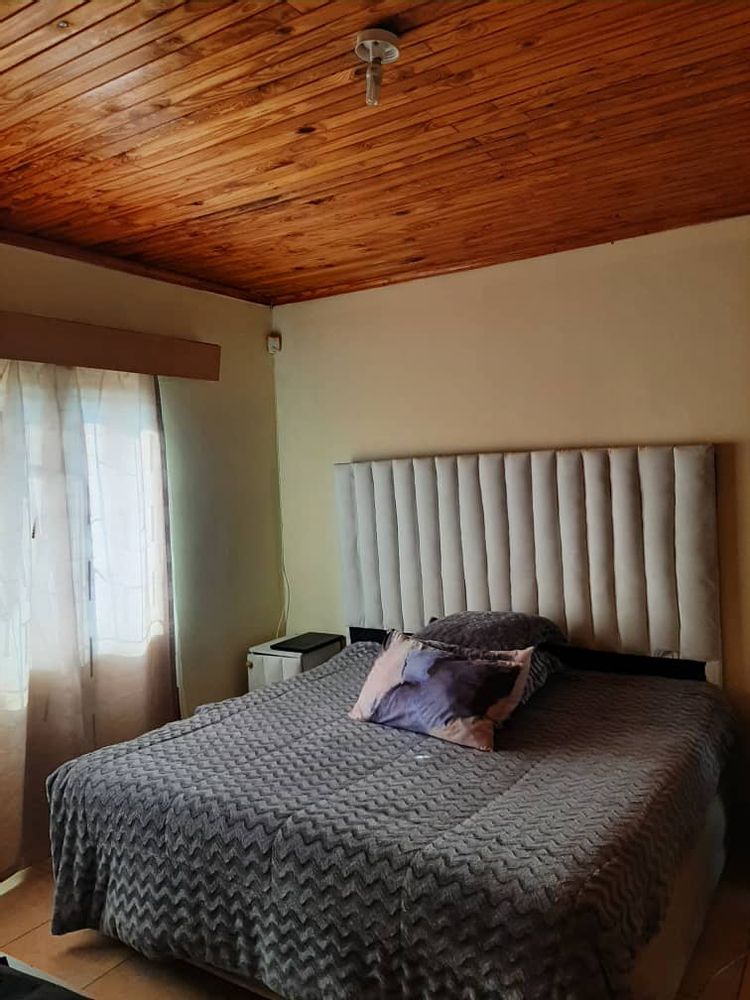 Main bedroom with wooden ceiling.