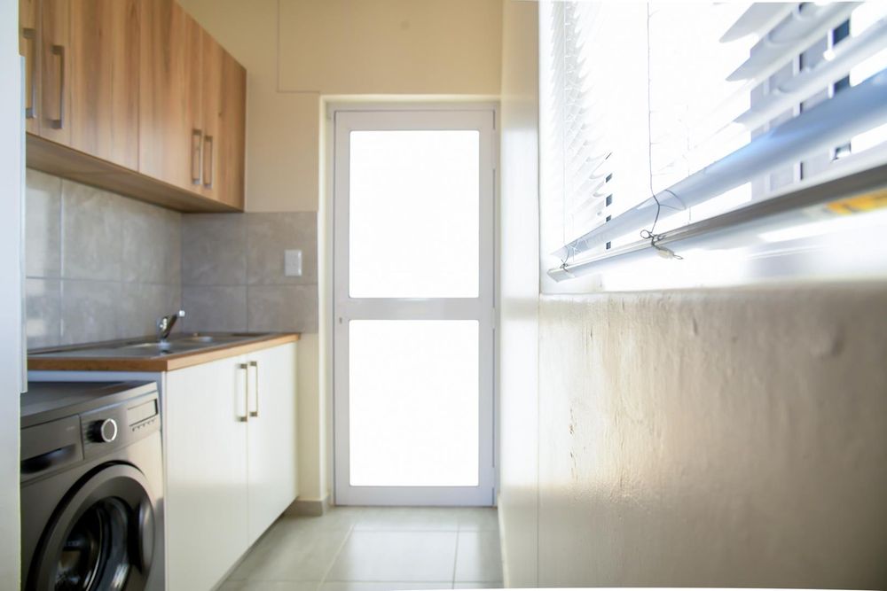 Kitchen scullery with even more cupboards.
