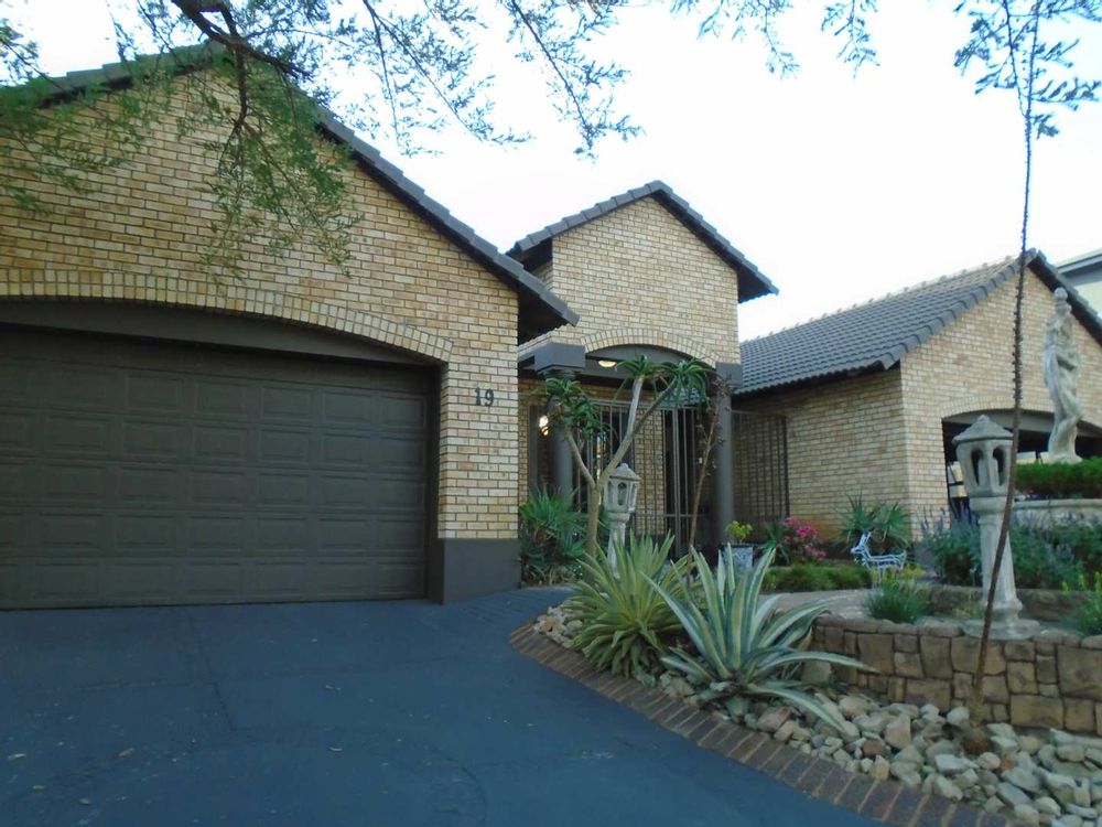 front garden with 2 x double garages on each side of the house