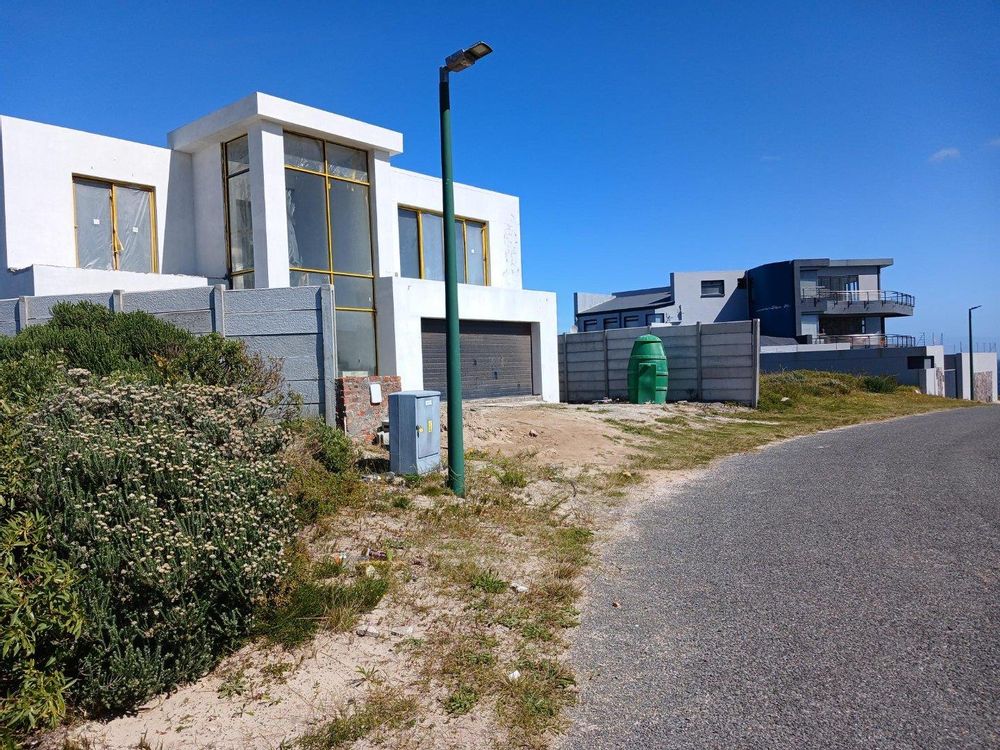 Our Plot on our left; thereafter, 2 upmarket Houses directly next to us (in the direction of the Sea). 1 House in the process of being built.