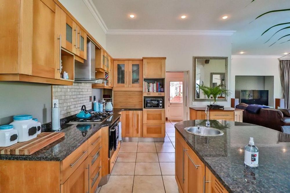 DESIGNER KITCHEN OPEN PLAN TO SCULLERY AND LOUNGE BAR AREA 