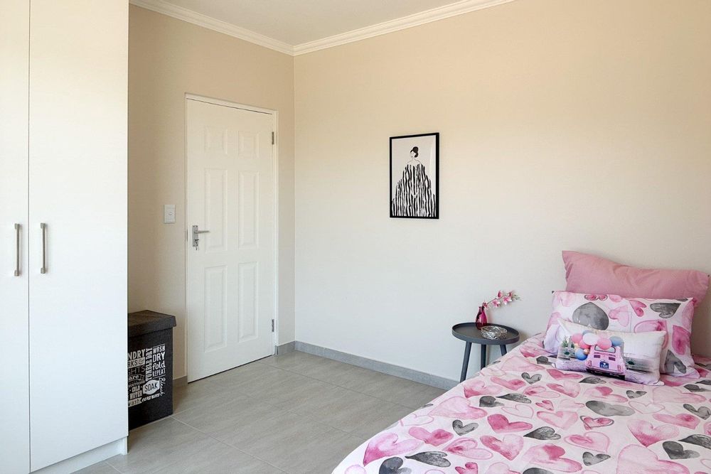 Second bedroom with built-in cupboards.