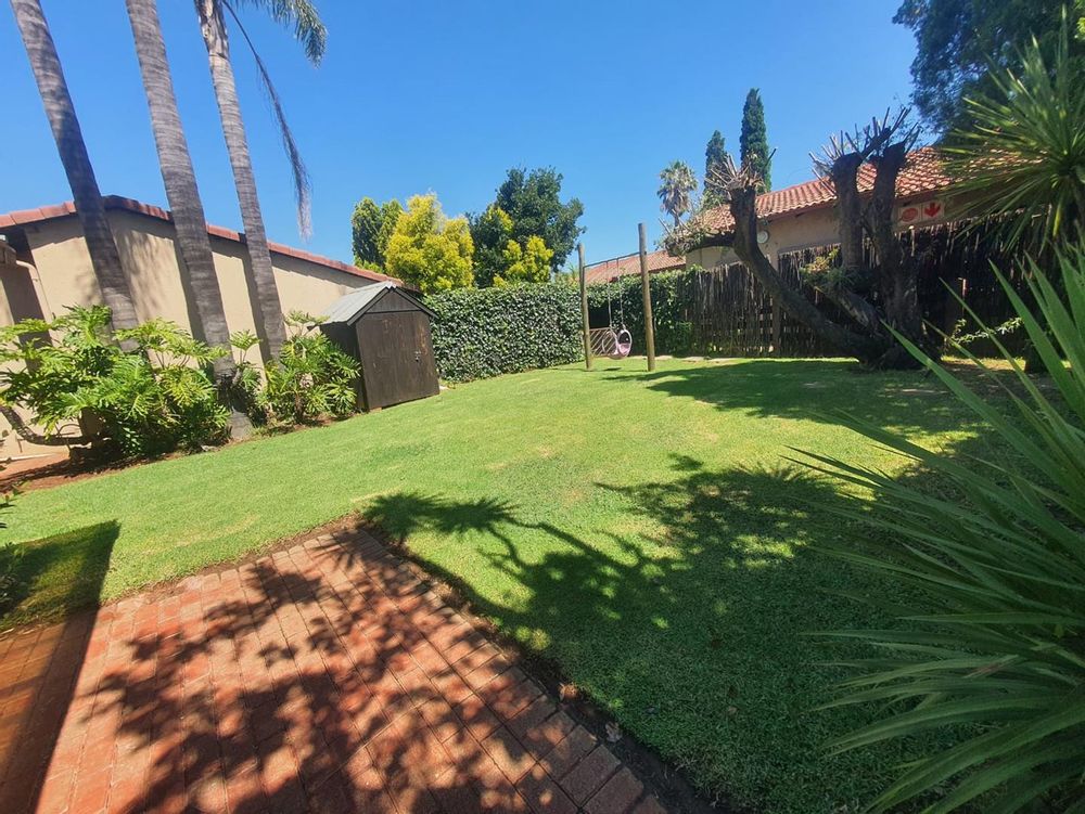 Well maintained garden with tool shed for personal gardening equipment