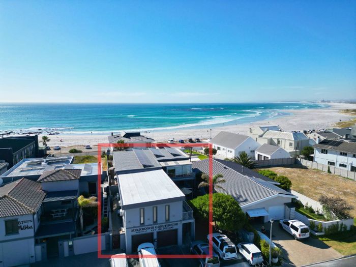 For Sale: Guest House in Melkbosstrand Central with 8 rooms, solar power, and parking.