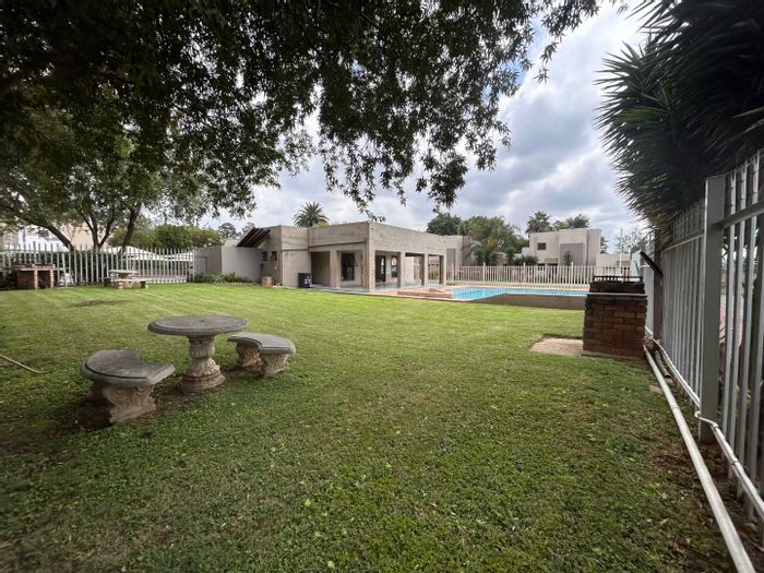 Townhouse For Sale in New Market Park: Pool, clubhouse, tennis court, and gardens.