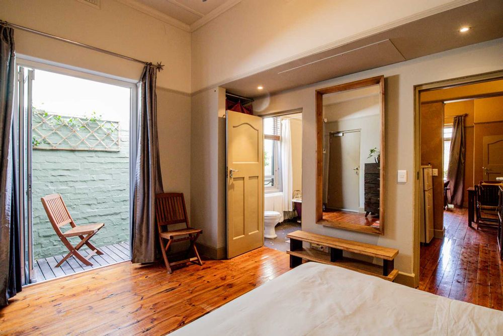 bedroom en suite with door opening to side terrace