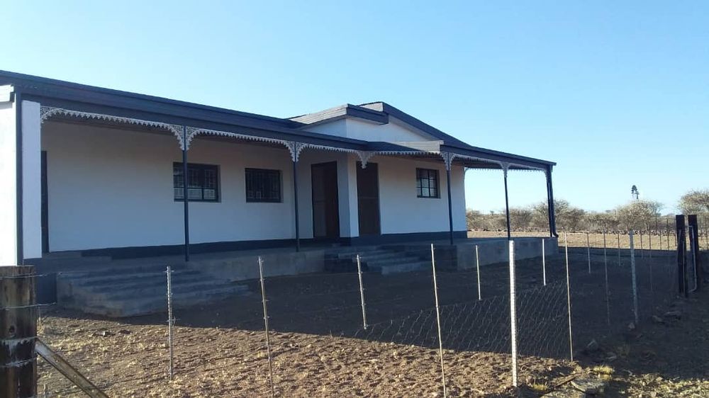 Front view of the second house. Fencing surrounding the house