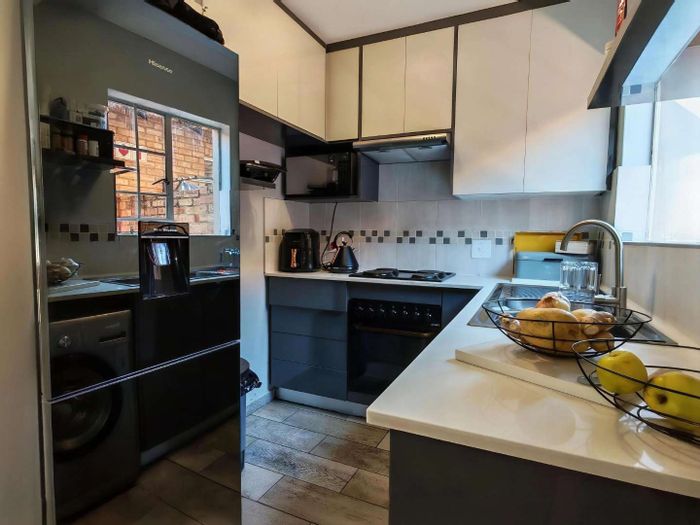 Townhouse To Rent in Oukraal Estate: 3 beds, 2 baths, double garage, low-maintenance garden.