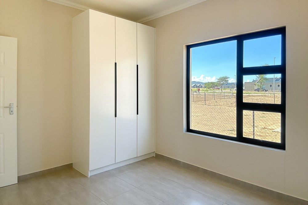 Second bedroom with built-in cupboards.