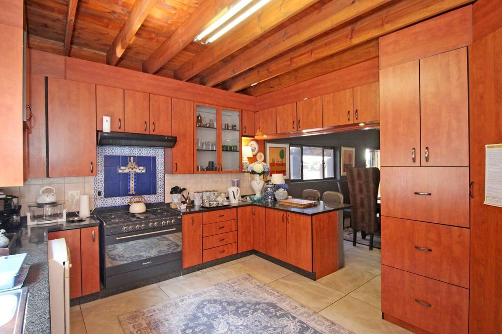 Beautiful kitchen with ample built-in cupboards, pantry, gas stove with electric oven and breakfast nook