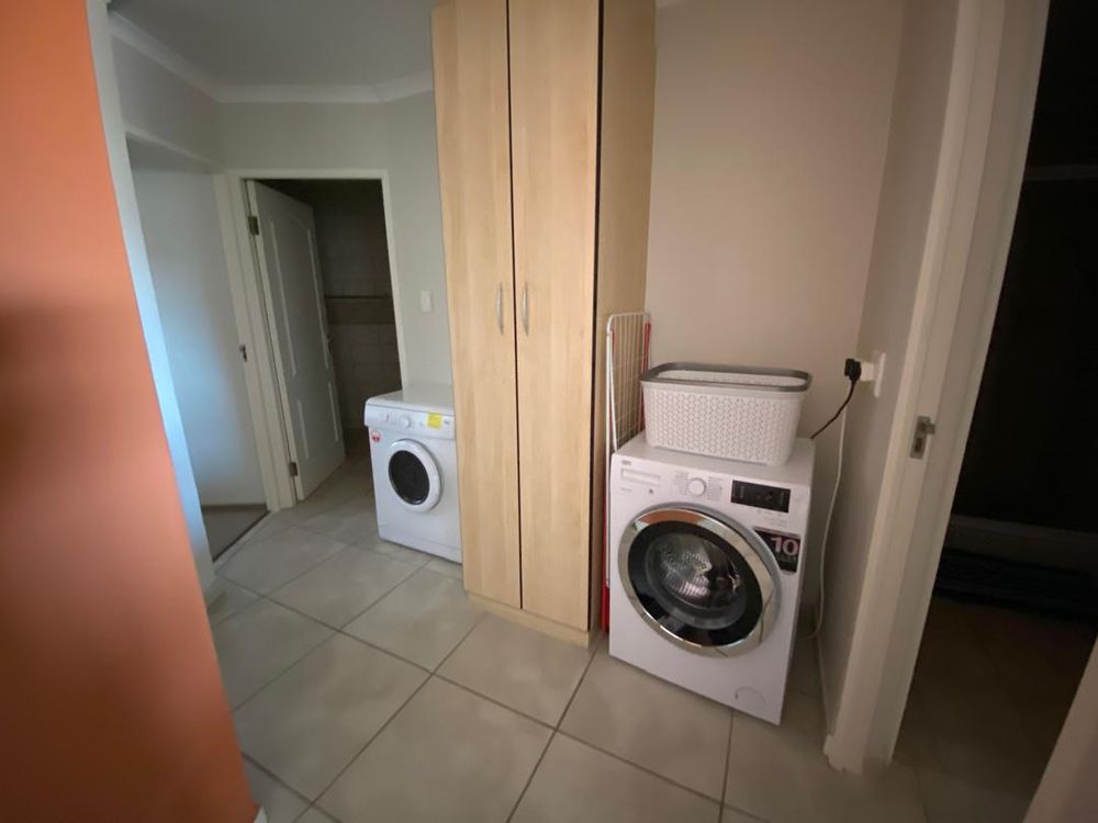 Hallway between rooms where the washing machine and dryer are kept