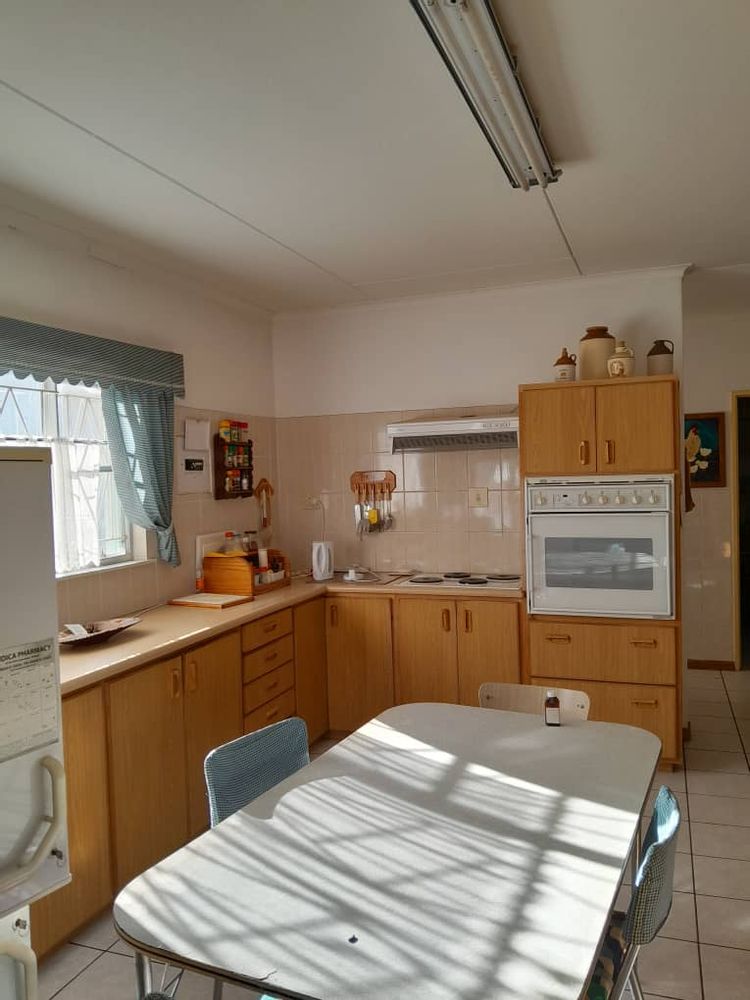 Kitchen with built-in cupboards, stove and oven