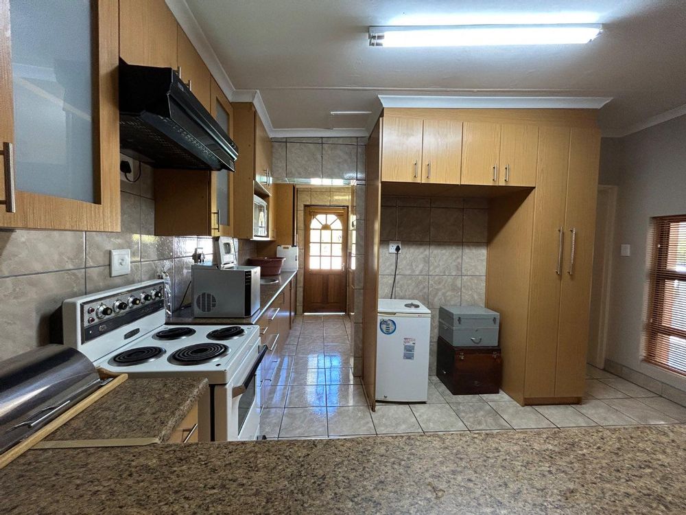 Bachelor flat kitchen and entrance to bathroom.