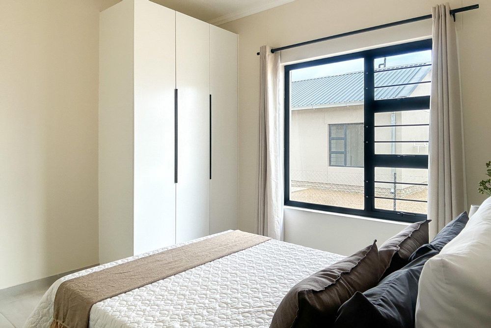 Third bedroom with built-in cupboards.