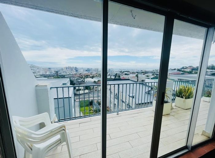 Vredehoek Apartment To Rent: 2-bedroom, balcony views, near Kloof Street amenities.